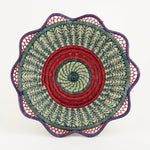 The Voyage Dubai. Handmade by skilled artisans in Sololá, Guatemala, the Josefina basket is delicately handwoven from native grass and pine needles with colourful raffia accents and a scalloped rim. Functional as well as beautiful, the basket makes a wonderful wall or tabletop accent.  Handmade and fair trade.  Origin – Guatemala  Material - native grass, pine needles, raffia  Approximate Dimensions: 11" diameter x 2.25" high