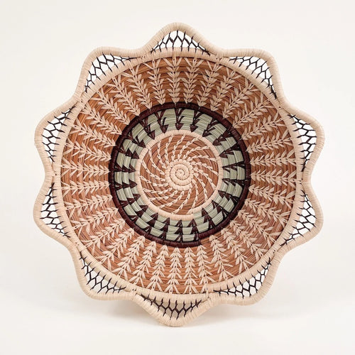 The Voyage Dubai. Handmade by skilled artisans in Sololá, Guatemala, the Catarina basket is delicately handwoven from native grass and pine needles with raffia accents. Functional as well as beautiful, the basket makes a wonderful wall or tabletop accent.  Handmade and fair trade.  Origin – Guatemala  Material - native grass, pine needles, raffia  Approximate Dimensions: 11" diameter x 2.25" high
