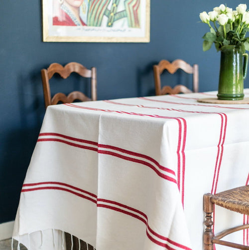 The Voyage Dubai - Lunch in Tangier Tablecloth - Red and White Stripe Tablecloth  Made from a wonderfully soft yet highly durable handwoven cotton, the Lunch in Tangier tablecloth is perfect for everyday use and equally stunning dressed up for a special occasion. A truly versatile piece that will have you reaching for it time and time again.