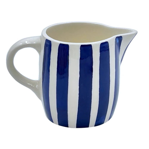 The Voyage Dubai - Milk Jug in Navy Stripes  Handmade and hand painted in Malta in contemporary thick stripes, designed to complement the rest of the Villa Bologna collection. The chunky bands of colour are as brilliant on their own as they are when paired with the scroll pattern and/or the Palm pieces.