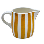 The Voyage Dubai - Milk Jug in Yellow Stripes  Handmade and hand painted in Malta in contemporary thick stripes, designed to complement the rest of the Villa Bologna collection. The chunky bands of colour are as brilliant on their own as they are when paired with the scroll pattern and/or the Palm pieces.