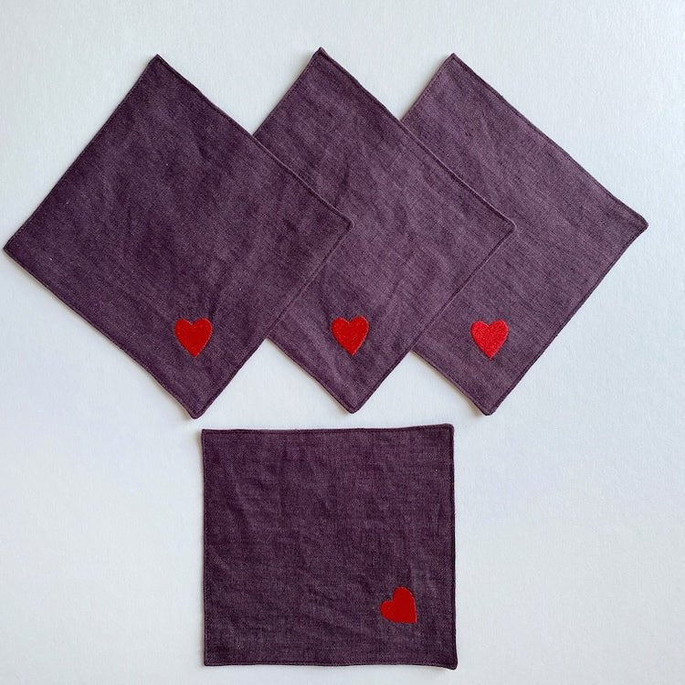 The Voyage Dubai - Seeing Hearts Cocktail Napkins in Plum (Set of 4) - A plum and red pairing with beautifully embroidered heart motifs. Great for any season, perfect for Valentine's -  Our cocktail napkins are handcrafted from 100% European linen that has been stonewashed and softened giving them a wonderful, luxurious feel. 
